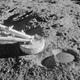 A Surveyor 3 footpad rests on the dusty lunar surface. The imprint was caused by the probe bouncing off the surface during landing.